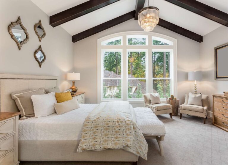 master-bedroom-in-new-luxury-home-with-chandelier-and-large-bank-of-windows-with-view-of-trees-1222623844-212940f4f89e4b69b6ce56fd968e9351
